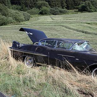 Mit Cadillac beladener Auto-Anhaenger kommt von der Fahrbahn ab