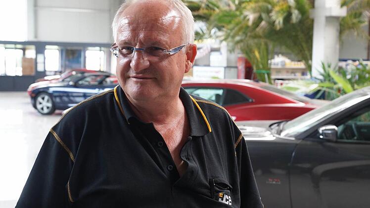 Willibald Klarmann vor seinen Lieblingsautos im Hintergrund.Foto: Sarah Dann