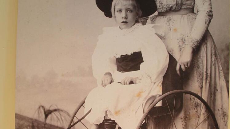 Eine alte Fotografie zeigt Mutter und Tochter auf einem Dreirad. Hier saß Frau zwar bequem, aber das Fahren war immer noch relativ anstrengend.