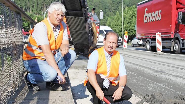 Horst Moser und Jens Laußmann (rechts) vom Staatlichen Bauamt Bamberg sehen sich die angegriffene Fahrbahn an.  Fotos: Franziska Rieger