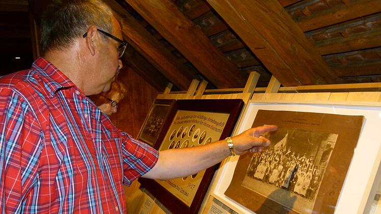 Michael Niedermaier vom Oberen Gärtnerverein sucht in einemGruppenbild identifizierbare Gesichter.                Fotos: Marion Krüger-Hundrup