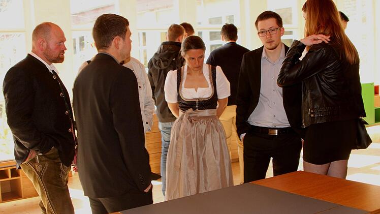 Fachgespräche vor dem Meisterstück eines Schreibtisches.