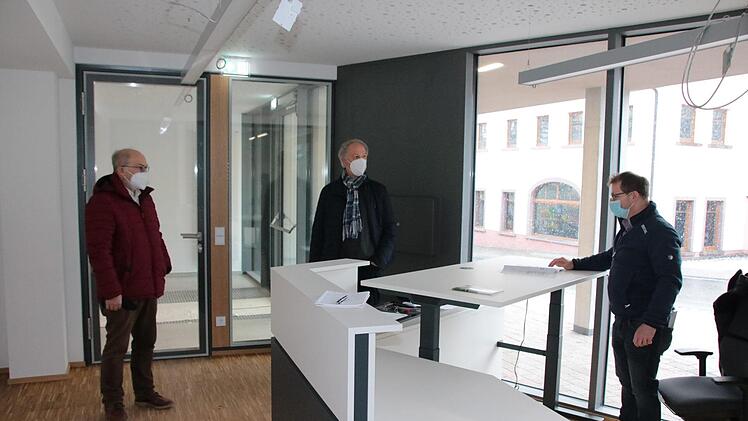 Hans-Jörg Kaiser (rechts) von der technischen Bauverwaltung der VG bespricht im künftigen Bürgerbüro letzte Details mit dem VG-Vorsitzenden August Weingart (von links) und dem Euerdorfer Bürgermeister Peter Bergel. Zur Ausrüstung der Büros gehören auch höhenverstellbare Tische. Foto: Ralf Ruppert