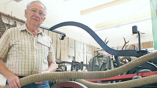 Felix Kreiner mit der Feuerspritze aus dem Jahr 1888: Sie ist sein Lieblingsst&uuml;ck, da er 42 Jahre lang bei der Feuerwehr und davon 29 Jahre Gruppenf&uuml;hrer war.  Foto: Manfred Welker