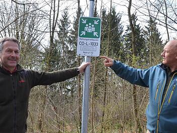 Henry Renner und Albert Schrenker zeigen eine Tafel, die auf einen Rettungstreffpunkt hinweist. Foto: Rainer Lutz