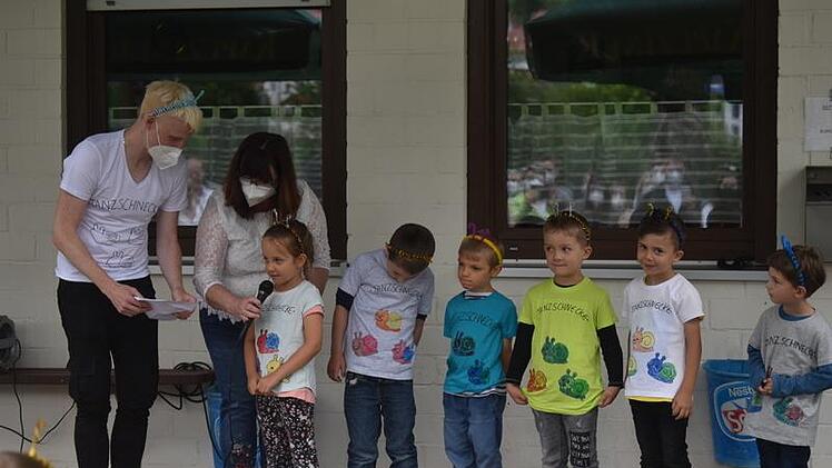 Kindergartenleiterin Claudia Kolb und Erzieher Matthias Schmitt mit den Kindergartenkindern bei der Aufführung der Tanzschnecken beim Kindergartenfest.