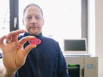 So kann es aussehen: Techniklehrer Ralf Heydemann zeigt einen Schlüsselanhänger, der mit dem neuen 3D-Drucker hergestellt wurde. Bis zu einer Größe von 15 Zentimetern kann mit diesem jeder Gegenstand aus einem speziellen Kunststoff ausgedruckt werden. Foto: Marian Hamacher