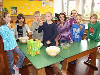 Lisa, Leonie, Niklas, Johnathan, Marie, Julia, Tim und Linda laben sich an Apfelmus und -saft, Kohlrabi und Paprika. Foto: Ralf Kestel