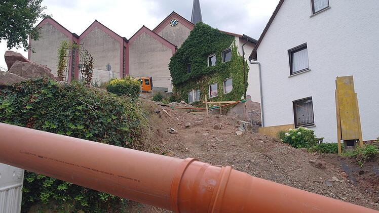 Hier war mal eine Treppe. Momentan wird der Mischwasserkanal, der für Erhöhung der Sanierungskosten sorgt, provisorisch über das Nachbargrundstück verlegt, bis die Stützmauern und Fundamente der neuen Treppenanlage eingebaut sind. Foto: Stephanie Elm
