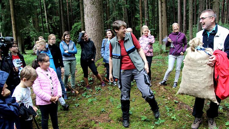 Alfred Sammetinger (r.) bekam von den Schülern und Försterin Heike Grumann einen Sack voller Kiefernzapfen als Geschenk.    Foto: Richard Sänger