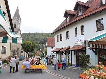 Die Bürger feiern vor dem künftigen Dorfladen (rechts) in der Hauptstraße in Unterleinleiter Erntedankmarkt mit Weinfest. Fotos: fra-press