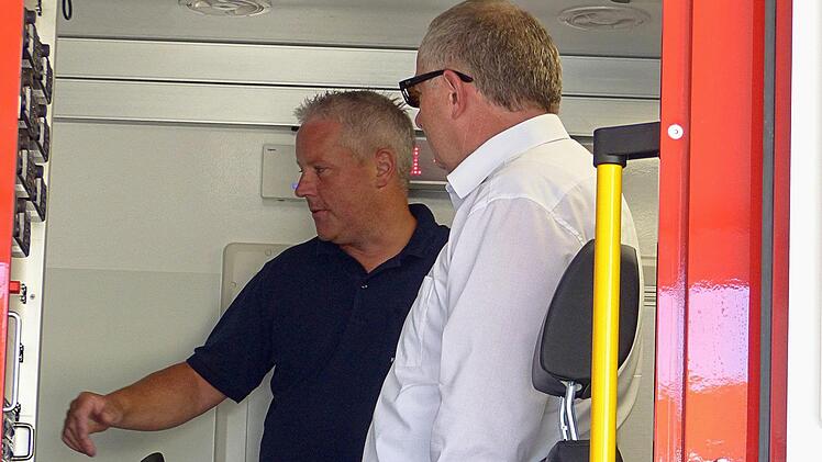 Marco Braunschweig und Thomas Kuhn erkunden die Arbeitsplätze im neuen Fahrzeug.