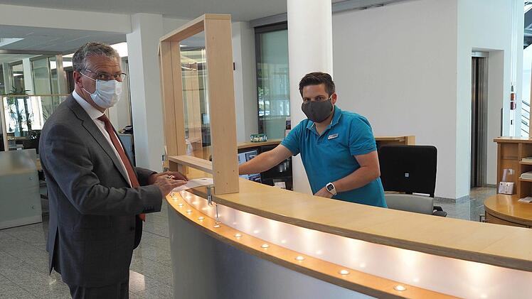 Plexiglasscheiben im SÜCenter in der Bamberger Straße sowie am Theaterplatz minimieren das Infektionsrisiko, zeigt SÜC-Geschäftsführer Wilhelm Austen (links). Das vorbildliche Pandemiemanagement des Coburger Versorgungsunternehmens bestätigt jetzt ein Zertifikat des Verbandes der Bayerischen Energie- und Wasserwirtschaft.  Foto: Christoph Winter