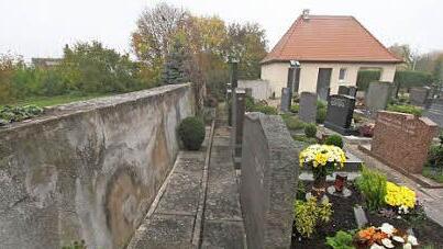 5. Die Friedhofsmauer in Neuhaus unterstützt die Totenruhe.