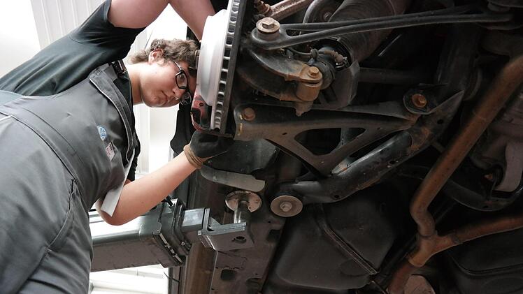 Bastian Geuß  schraubt an einem Wagen. Foto: Sarah Stieranka