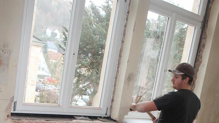 Christian Kotschenreuther von der Firma Bodenschlägel baut die neuen Holzfenster mit Thermoverglasung ein. Foto: Sonja Adam