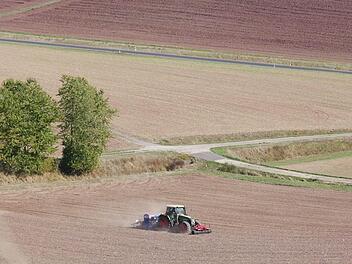 Ein Traktor bearbeitet sein abgeerntetes Feld und zieht eine Staubwolke hinter sich her - ein typisches Bild in diesem Jahr, weil auch der Herbst sehr trocken ist.Heike Beudert