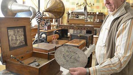 Jockel Müller zeigt eine Lochplatte - Vorläufer späterer Schallplatten.