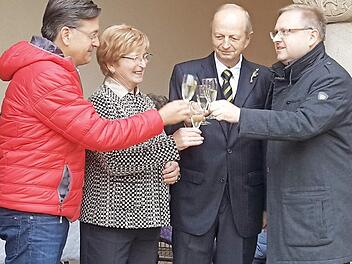 Bürgermeister Karsten Fischkal (links) und Pfarrer Thomas Ringer (rechts) stoßen mit Ehepaar Goß auf die Goldene Hochzeit an.  Foto: Blum