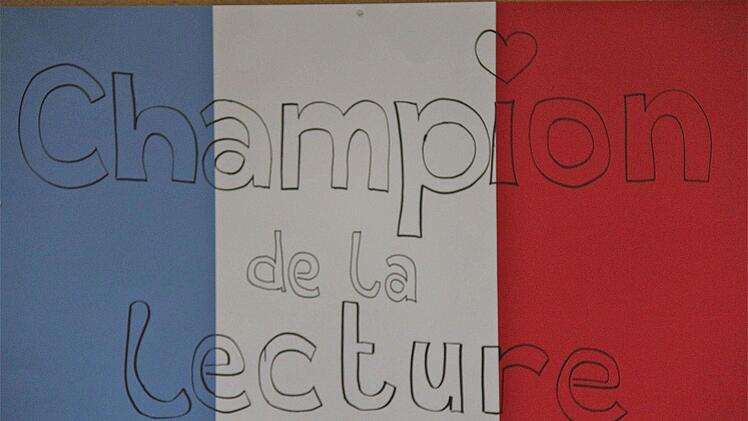 "Champion de la Lecture" in den Landesfarben ist das Logo des Wettbewerbs.