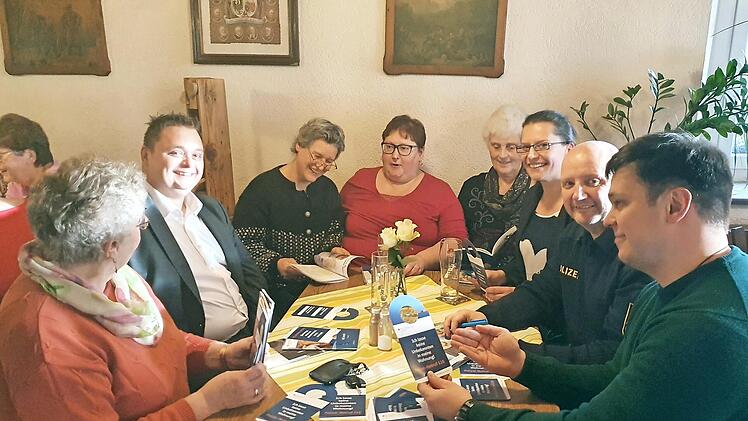 Klaus Steinhübl (rechts) zeigt den Zuhörern Marcus Müller, Ingrid Hilfenhaus, Diana Könitzer und anderen Informationsmaterial zum Thema "Trickbetrug".  Foto: Carmen Schwind