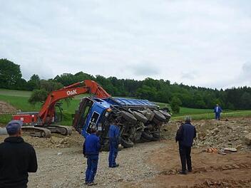 Mit einem Bagger wieder auf die Räder stellte die Baufirma den verunglückten Baustellen-Laster. Fotos: Feuerwehr Bad Brückenau