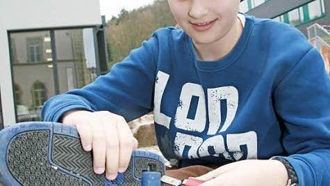 Mit einem Klick kann Tobias Albertz (12) die kleinen Rollen, die sich im Absatz des Turnschuhs verbergen, anmontieren.