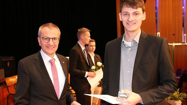 IHK-Hauptgeschäftsführer Siegmar Schnabel (links) überreichte Nicolas Schönmüller, dem besten Teilnehmer an der Winterprüfung 2016/17, bei der Feier am Donnerstag im Kongresshaus Rosengarten sein Abschlusszeugnis als Elektroniker für Automatisierungstechnik. Foto: Bettina Knauth