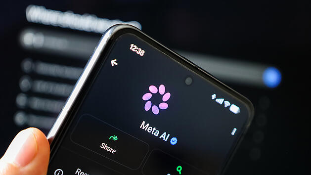 Phone in hand displaying Meta AI on WhatsApp