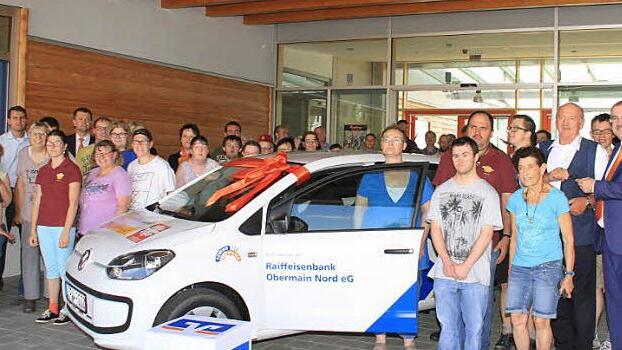 Freude auch bei den Beschäftigten: Vorstand Ulrich Klein von der Raiffeisenbank Obermain Nord überreicht dem Geschäftsführer der Werkstätten St. Joseph, Hans Vonbrunn, die Fahrzeugschlüssel.  Foto: Gerda Völk