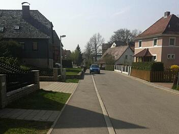 Das Stück Straße bis zu dem blauen Auto wurde jetzt als historische Straße anerkannt. Damit fallen für die Anlieger die Erschließungsgebühren für den Gehweg weg.  Fotos: Christiane Lehmann