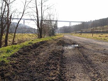 Da Traktoren den Schlaglöchern ausweichen, verbreitert sich der Feldweg entlang der kleinen Sinn in Richtung Autobahnbrücke.  Foto: Elm