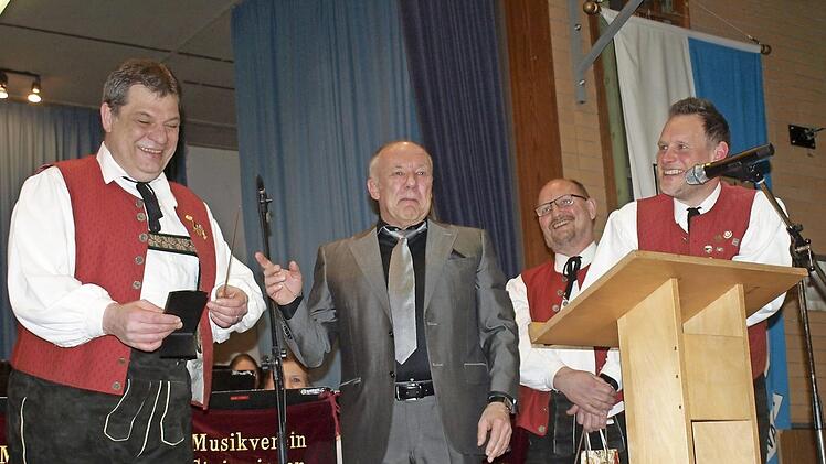 Eine kleine Überraschung zum 30-jährigen Dirigentendasein: Wolfgang Schrepfer (links) bekam vom Vorsitzenden des Musikvereins Steinwiesen, Stefan Hümmer (2. v. links) und seinem Stellvertreter Frank Hauck (rechts) einen goldenen Dirigentenstab überreicht. Foto: Susanne Deuerling