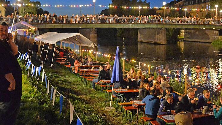 Wunderschöne Abendstimmung am Fluss - so lieben die Bamberger und die Besucher die Sandkirchweih. Doch langfristig ist der Festbetrieb bedroht: Gestiegene Sicherheitsanforderungen und hohe Kosten stellen die bisherigen Veranstalterstrukturen in Frage.  Foto: Ronald Rinkelf