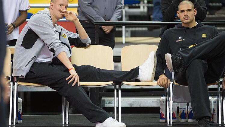 Deutschlands Robin Benzing (links) und Maik Zirbes (rechts), beide verletzt, beobachten das Aufwärmen ihrer Teamkameraden vor dem Spiel Foto: Lukas Schulze/dpa
