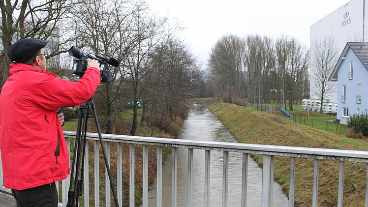Wo sollen die Millionen für den Kulmbacher Hochwasserschutz verbaut werden? Simon Trapp vom Bayreuther Büro des Bayerischen Rundfunks bei Filmaufnahmen an der Brücke in der E.-C.-Baumann-Straße. Foto: Stephan Tiroch