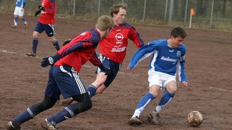 Die Eberner Zürl (links vorne) und Fischer (rotes Trikot, daneben) stören den Stegauracher Spieler, so dass dieser den Ball nicht wie gewünscht nach vorne spielen kann.