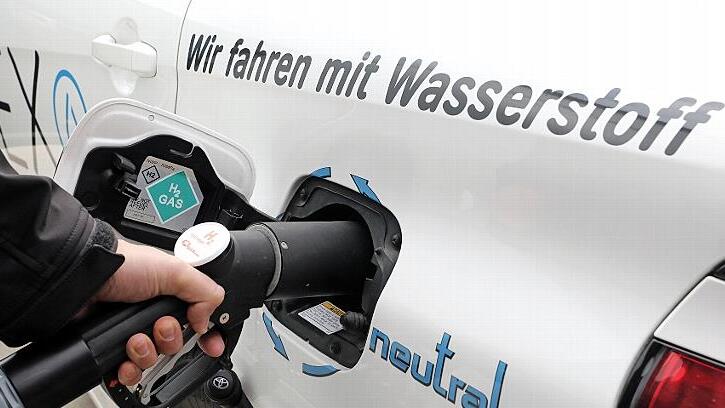 Ein E-Auto mit Brennstoffzelle wird mit Wasserstoff betankt.