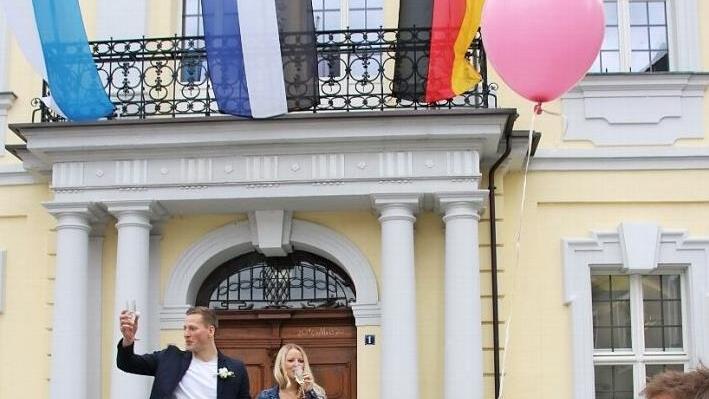 So sieht eine Hochzeit in der Corona-Krise aus - einsam stehen Nina und Jonas Hempfling nach der Trauung auf der Rathaustreppe. Bei der Zeremonie durften nicht mal die Eltern - rechts Brautvater Rüdiger Vetter - dabei sein. Foto: Christian Schuberth