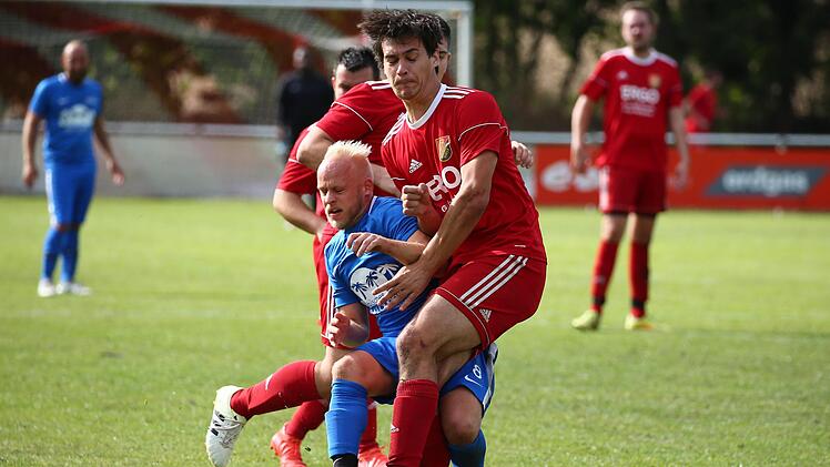 Relativ unsanft bremst der Johannisthaler Andreas Gaertig (rot) den Angriff von Mattghias Wildner. Foto: Heinrich Wei&szlig;