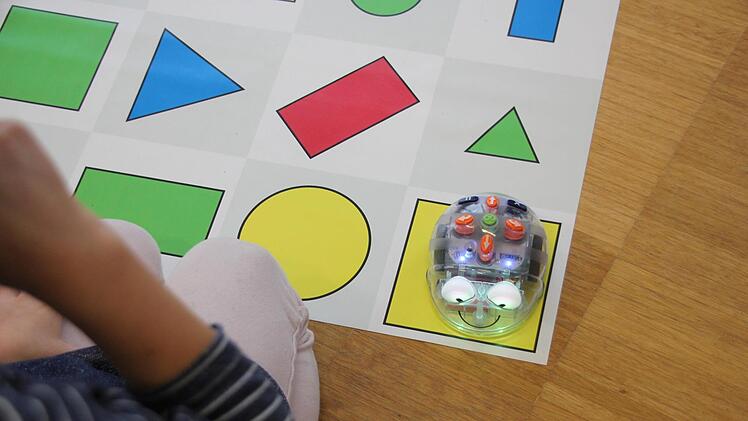 Die Kinder steuern die "Blue-Bot"-Roboter direkt über die Tasten.