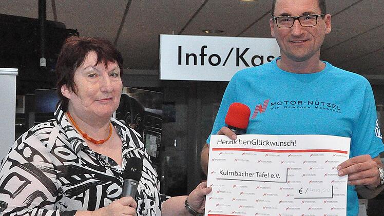 Ralf Becker von der Firma Nützel überreicht den Scheck über 1400 Euro an Elfriede Höhn von der Kulmbacher Tafel. Foto: Karl Heinz Weber