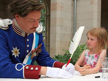 König Ludwig I., alias Holger Buczynski, gibt Franziska ein Autogramm. Voll Bewunderung beobachtet die Kleine das.  Foto: Kathrin Kupka-Hahn
