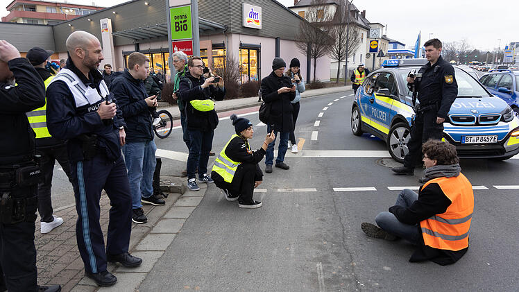 Bayreuth: "Letzte Generation" demonstriert im Stadtgebiet - Klima-Aktivisten kleben sich auf Stra&szlig;e fest