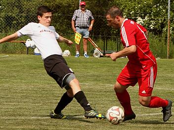 Der Untersteinbacher Marco Behringer (links) spitzelt dem Gästespieler den Ball vom Fuß.