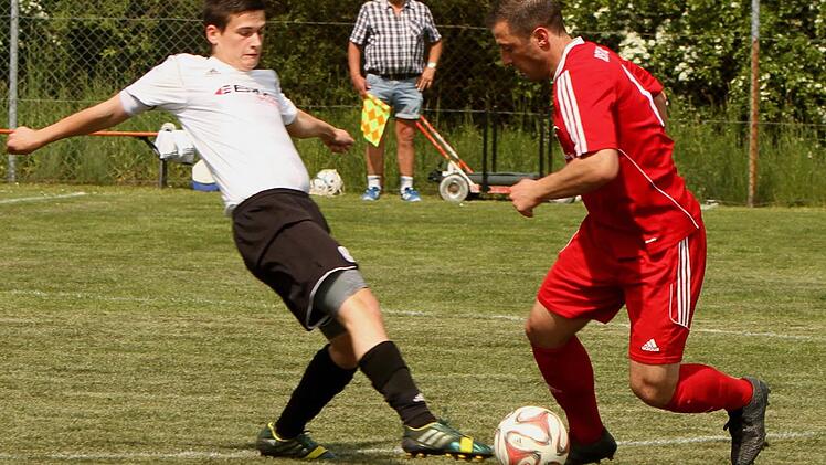Der Untersteinbacher Marco Behringer (links) spitzelt dem Gästespieler den Ball vom Fuß.
