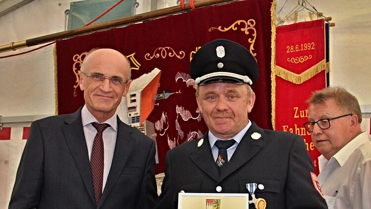 Eine Ehrenurkunde vom Landrat (links) gab es für den Kommandanten der Feuerwehr Losbergsgereuth-Ottneues, Thomas Lochner zum 125. Gründungsfest. Rechts: Bürgermeister Willi Sendelbeck.