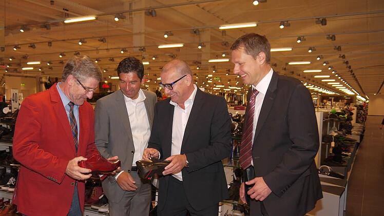 Ein roter Schuh musste es für Landrat Michael Busch schon sein, als er gemeinsam mit Frank Schuffelen, Thomas Mücke und Marco Steiner (von links) einen Rundgang durch den neu eröffneten "Schuh Mücke" in Rödental machte. Fotos: Berthold Köhler