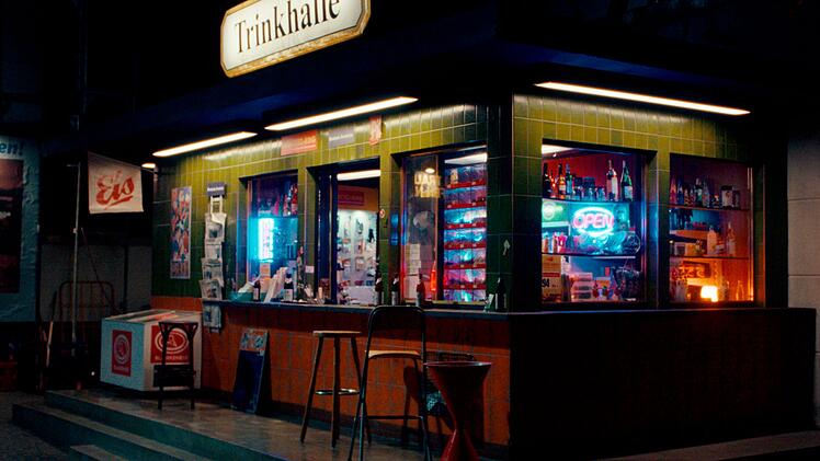 Hajos Kiosk in einer unspektakul&auml;ren Gegend Frankfurts bildet das Zentrum der ziemlich &uuml;berdrehten, mit h&ouml;chster Gagdichte ausgestatteten HR-Kom&ouml;die "Theken-Cowboys".