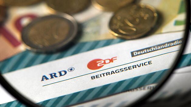Auf einem Tisch liegt M&uuml;nzgeld auf Formularen f&uuml;r B&uuml;rgerinnen und B&uuml;rger zu den Rundfunkbeitr&auml;gen ARD, ZDF und DRadio.Foto: Arno Burgi/dpa-Zentralbild/dpa